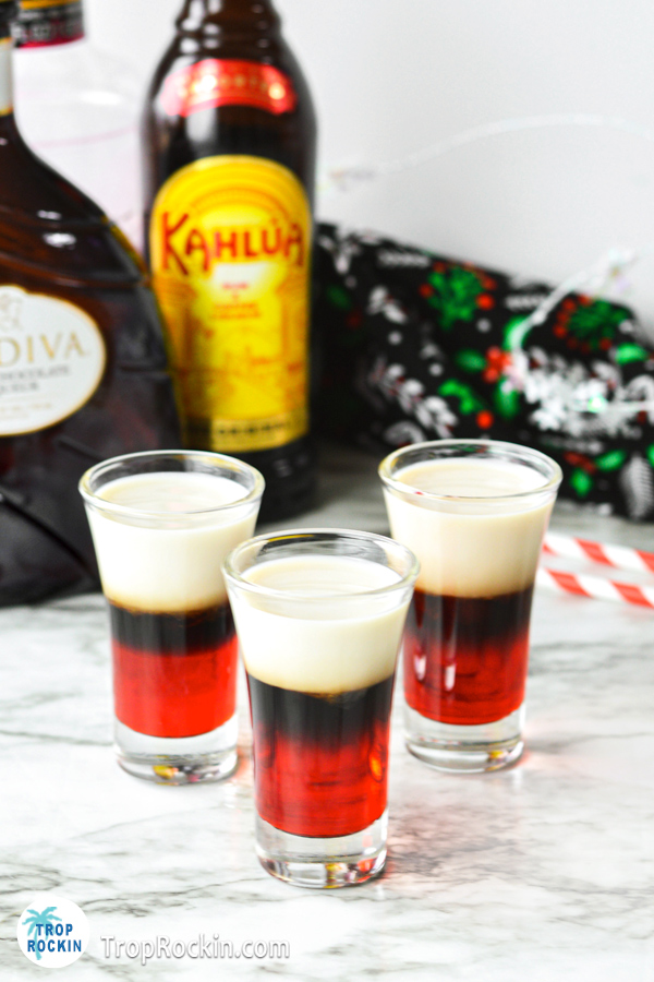 Santa Shooters on countertop with a Kahlua bottle and Godiva White Chocolate bottle in the background.