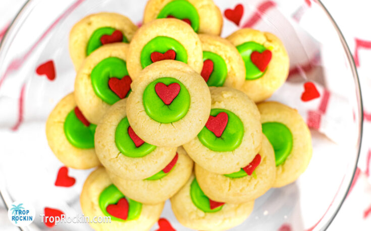 Grinch Thumbprint Cookies stacked in a large bowl.