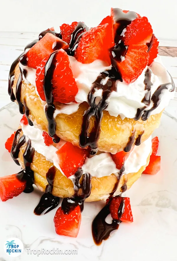 Donut strawberry shortcake dessert on plate.