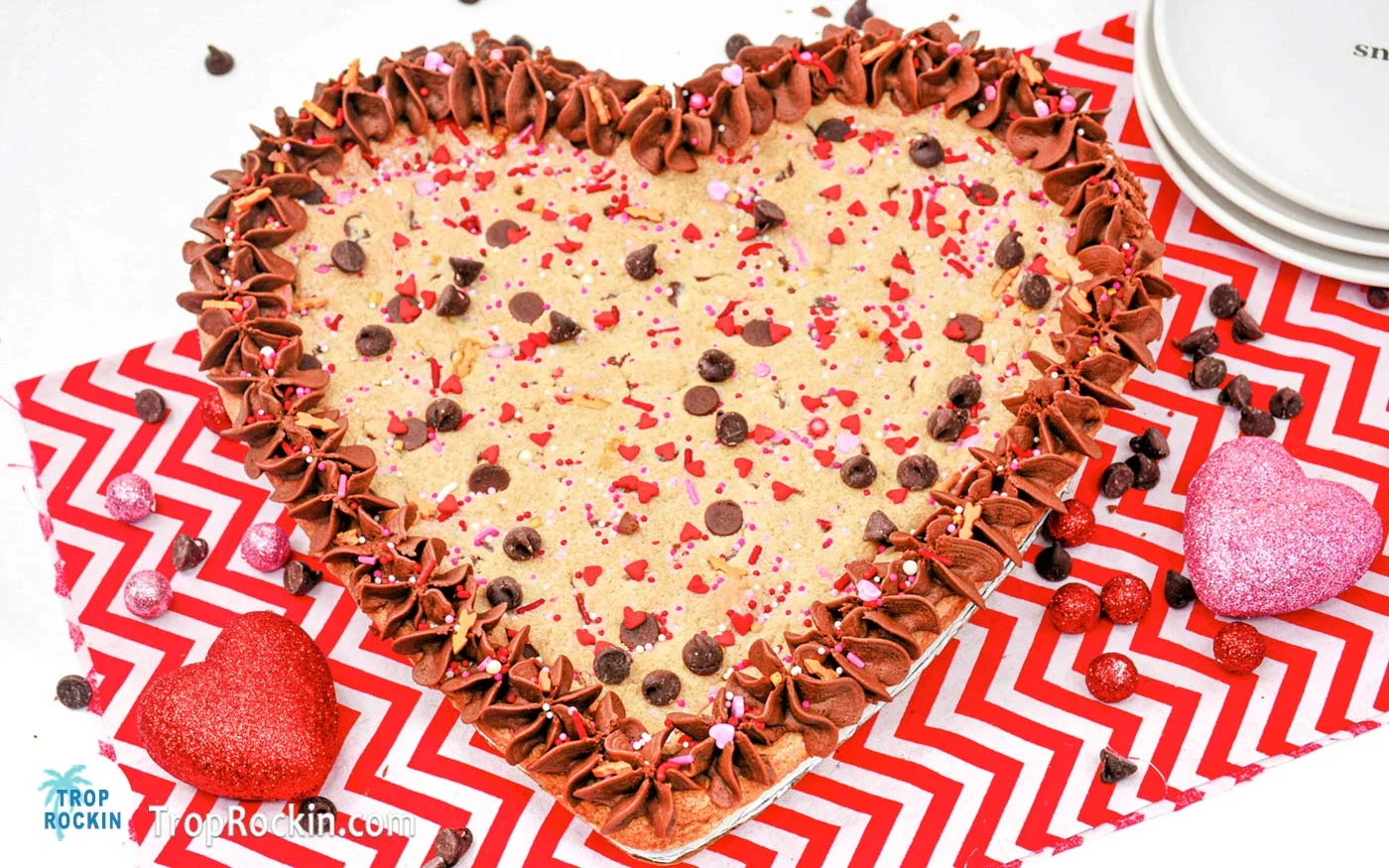 Valentines Cookie Cake heart shaped with chocolate chips, frosting and sprinkles.