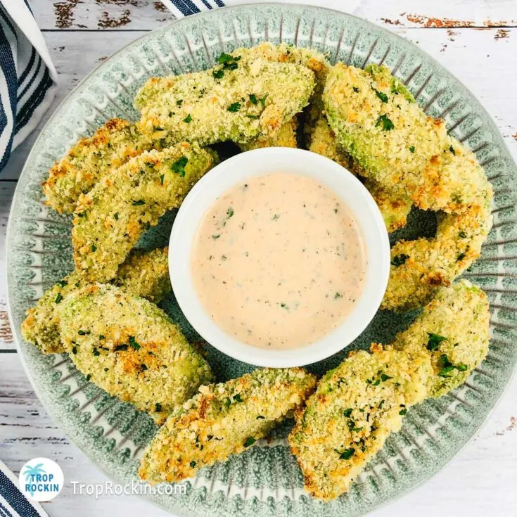 Air Fryer Avocado Fries on a plate with a bowl of dipping sauce in the middle.