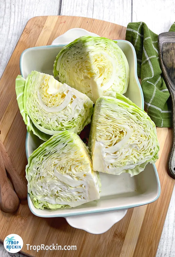 Cabbage cut into 4 quarters sitting in a serving tray.