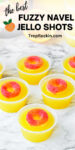 Text overlay on top with the recipe title and below is a photo of Fuzzy Navel Jello Shots with peach ring garnish displayed on marble counter top.