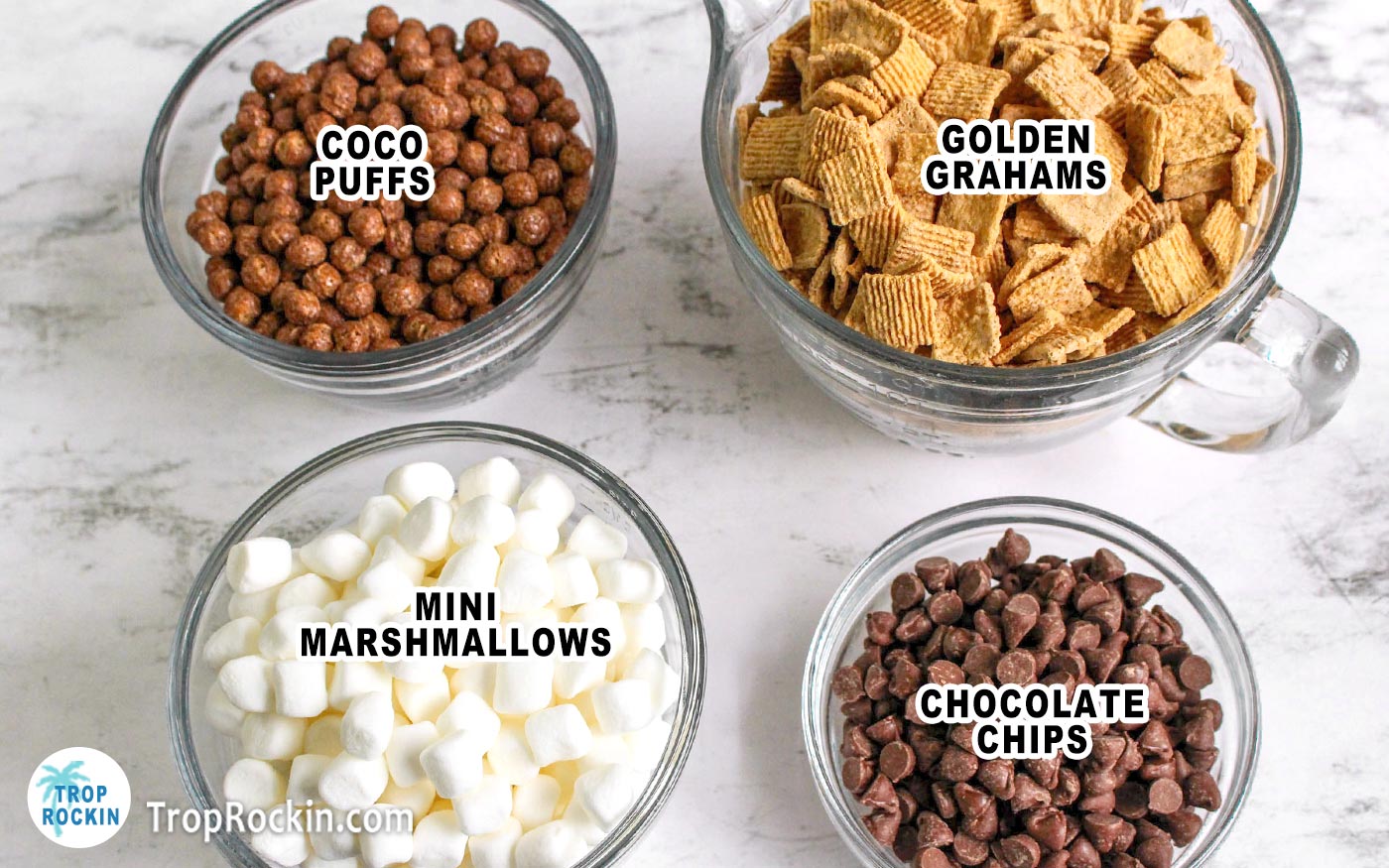 Smores snack mix ingredients in 4 seperate bowls on counter top.