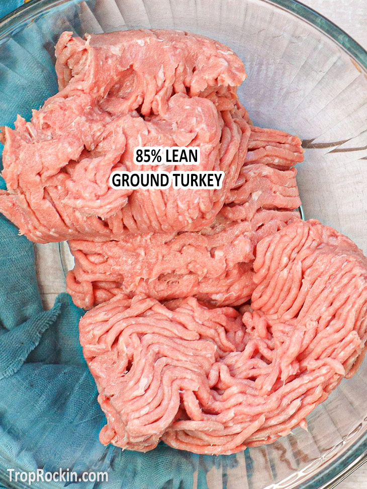 Large mixing bowl with raw ground turkey with text overlay that says "85% lean ground turkey".