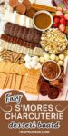S'more dessert charcuterie board with a variety of graham crackers, candy bars, dips, marshamllows and strawberries displayed on a charcuterie board. Text overlay that says "easy smores charcuterie dessert board" for sharing to social media.