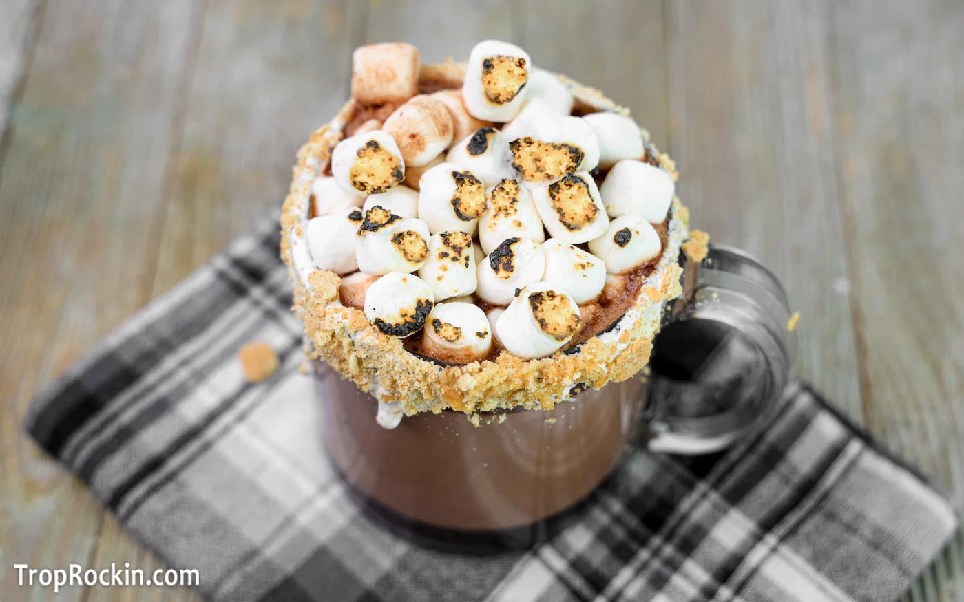 Mug of S'mores Hot Chocolate topped with toasted marshmallows.