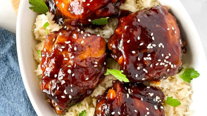 A plate of chicken thighs with sticky glaze.