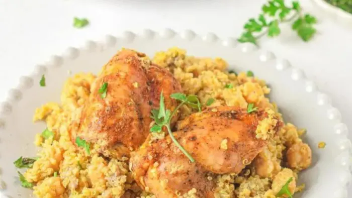 A plate of couscous with chicken breast.