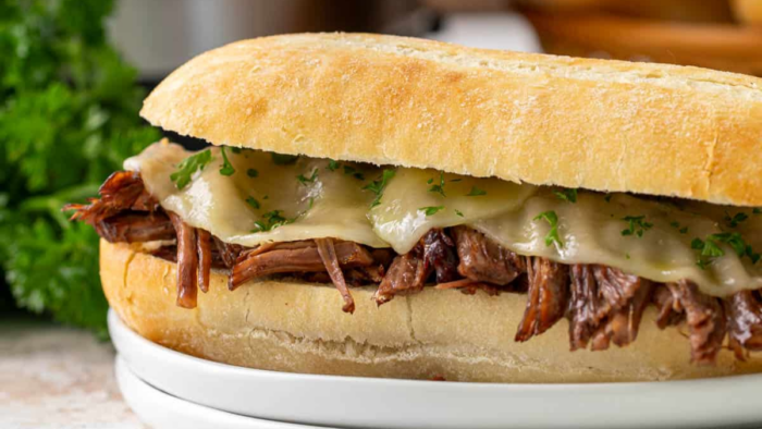 A french dip sandwich on a plate.