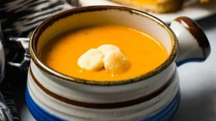 A bowl of creamy tomato basil soup.