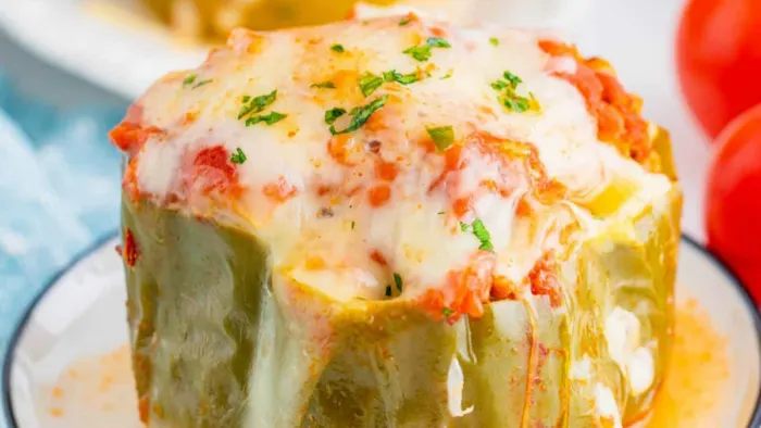 A plate of stuffed pepper with cheese.