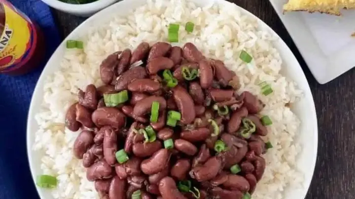 A bowl of red beans and meat over rice.