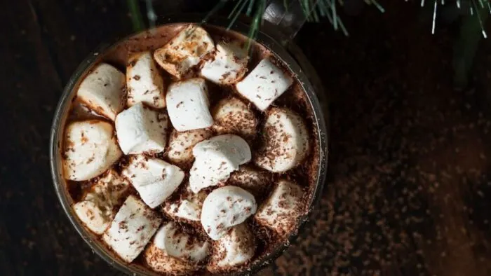 A mug of cocoa with plenty of melting mini marshmallows.