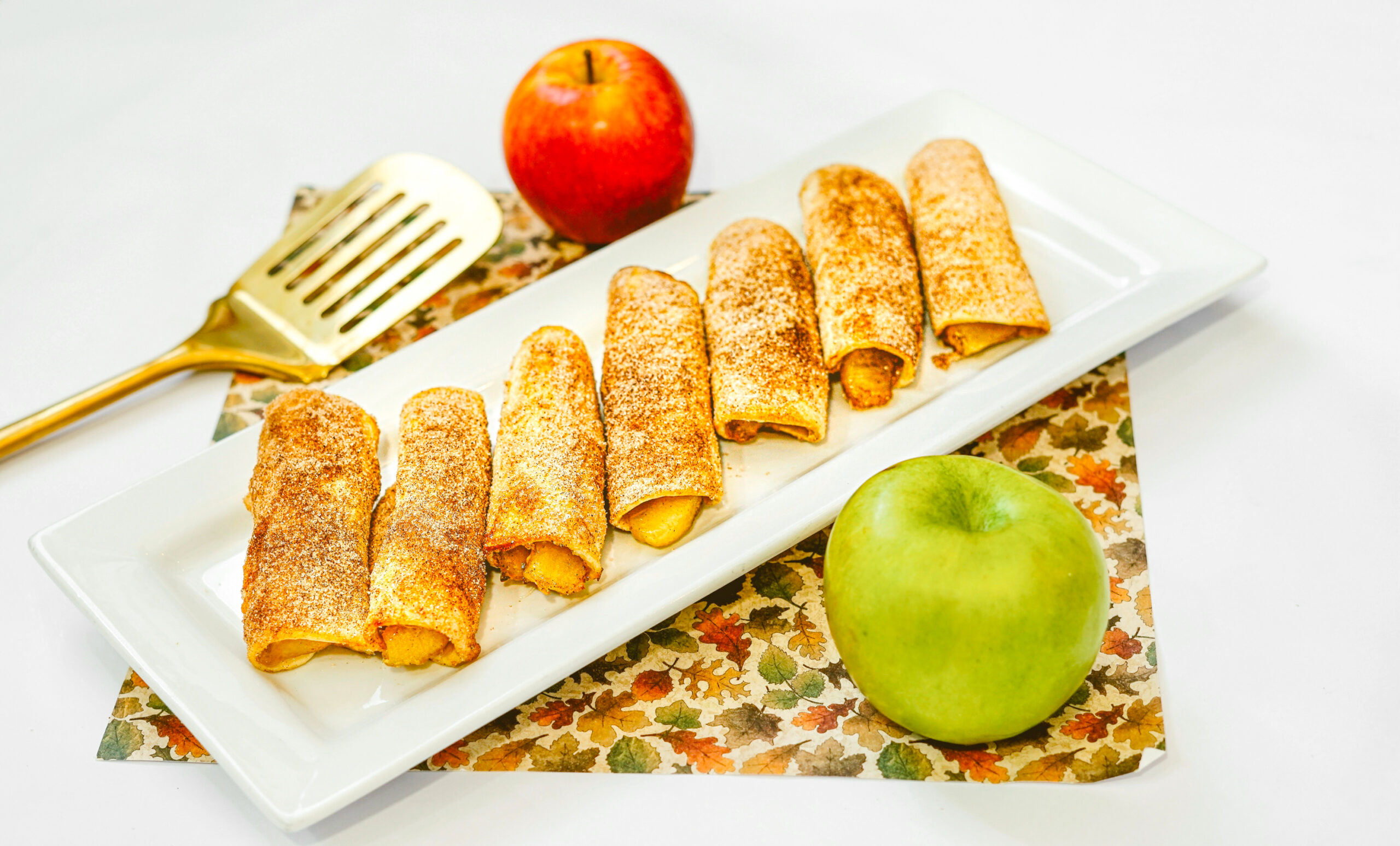 air fryer apple taquitos on a rectangular platter.