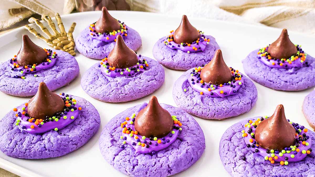 Plate with purple Witch Hat Cookies. Topped with purple icing, a hersheys kiss and halloween sprinkles.