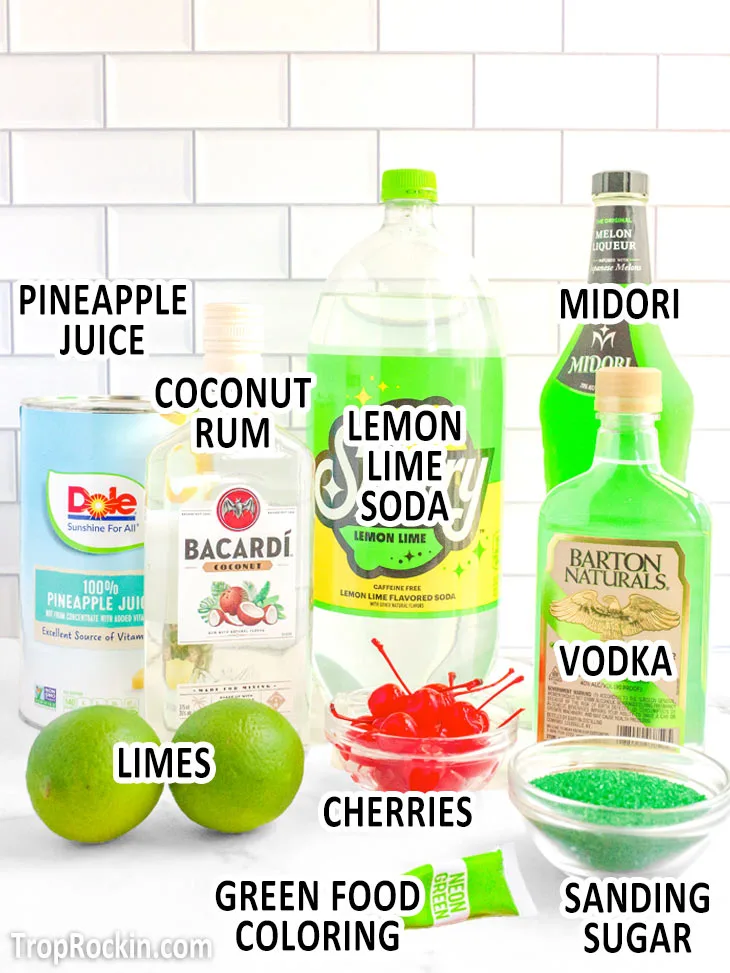 All Grinch cocktail ingredients displayed on countertop with text overlay labeling each ingredient.