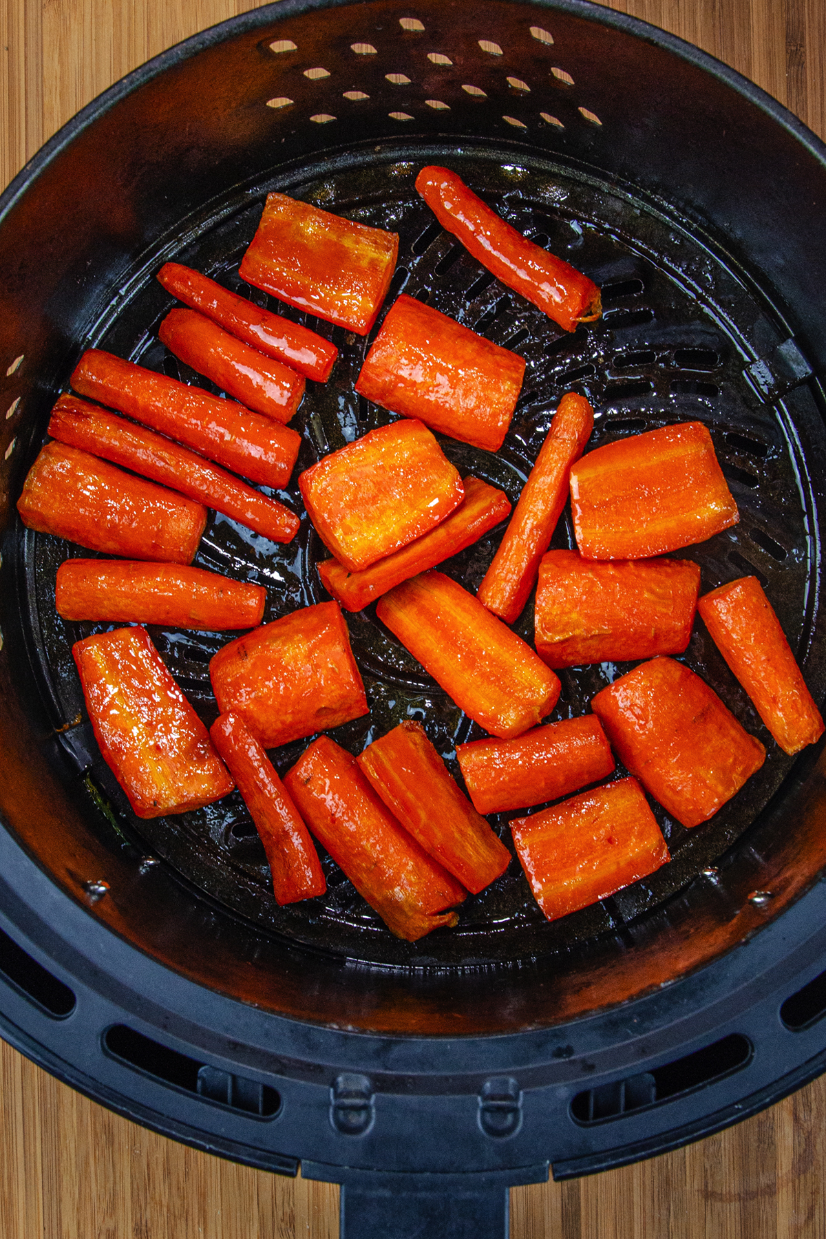 air fried carrots in air fryer basket.