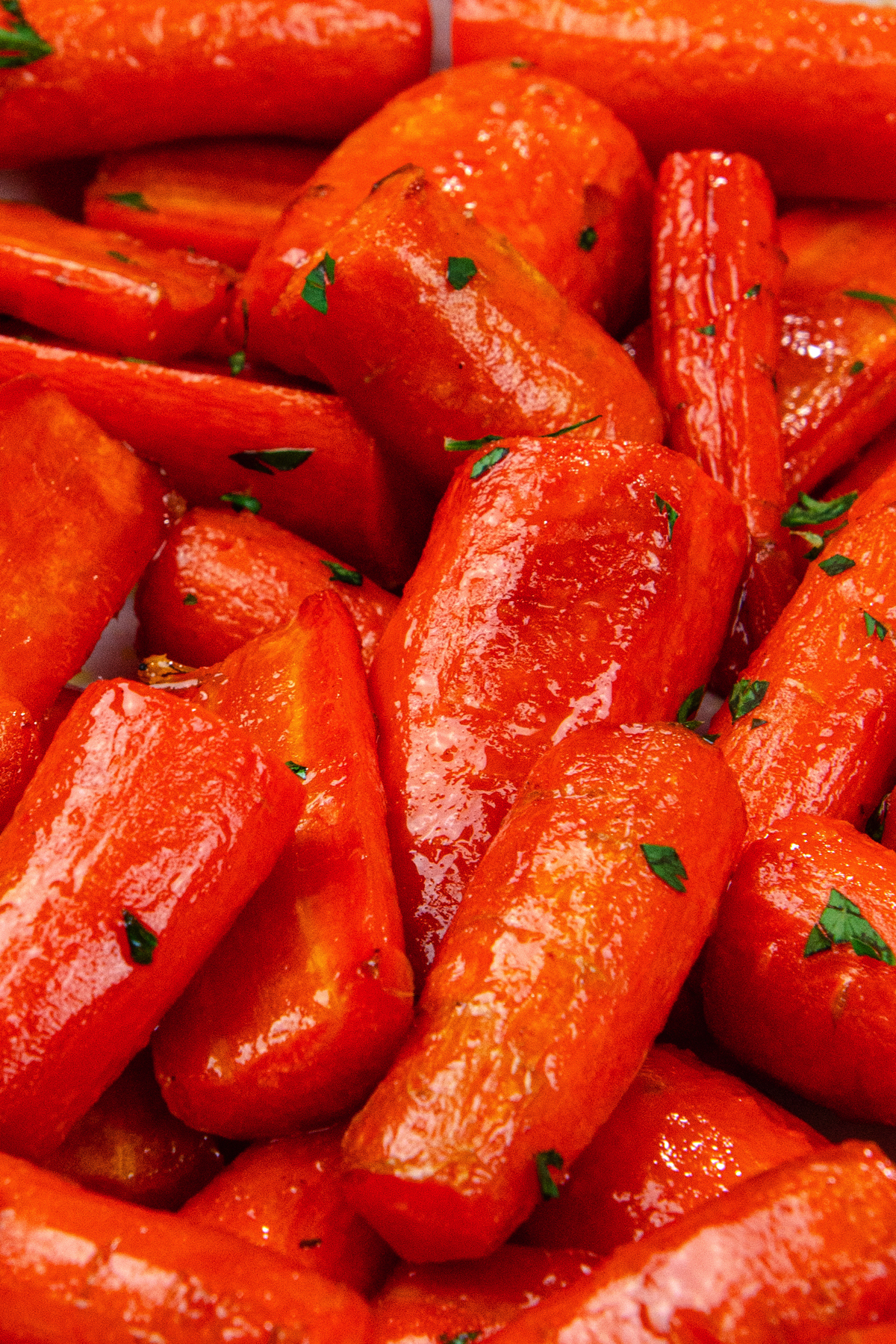 up close photo of cooked air fryer carrots garnished with parsley.