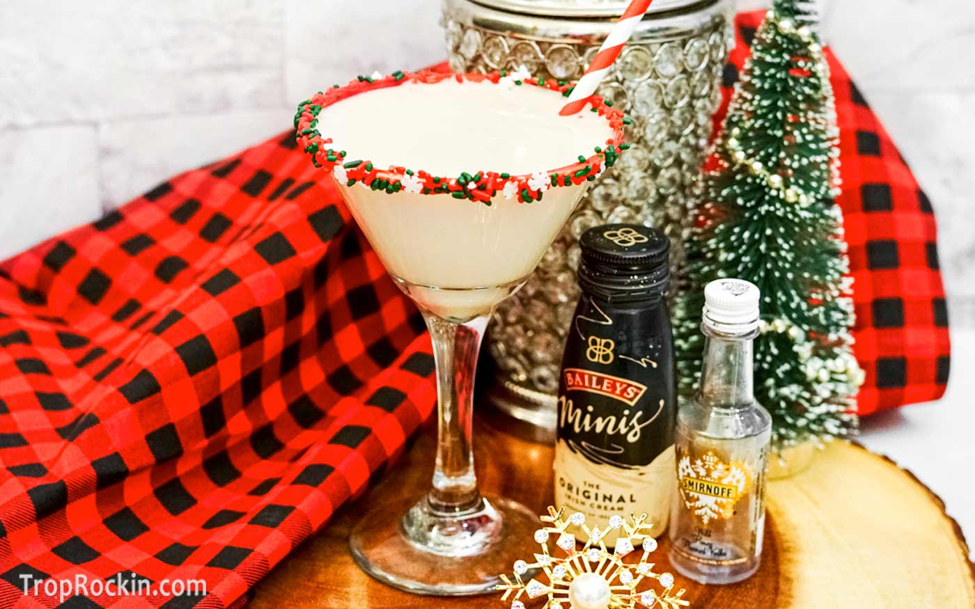Sugar cookie martini with red and green sprinkles on rim of a martini glass. 