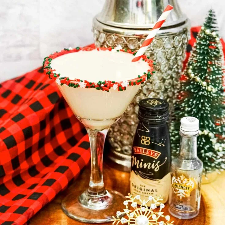 Sugar cookie martini with red and green sprinkles on rim of a martini glass.