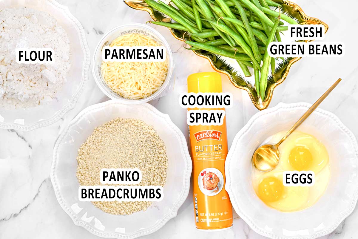 Air fryer green bean fries ingredients displayed in bowls on counter top and labeled with text overlay.