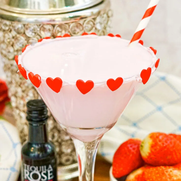 Chocolate strawberry martini with cocktail shaker and fresh strawberries in the background,