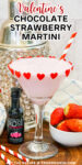 Valentine's Day Chocolate Strawberry Martini with cocktail shaker and bowl of fresh strawberries on a wood board. Text overlay with recipe title above the drink .