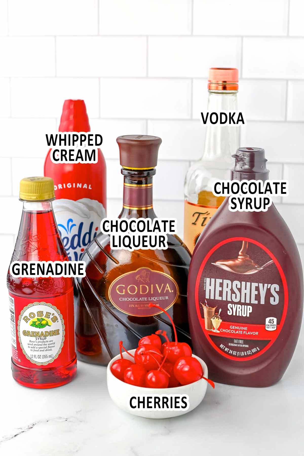 Chocolate covered cherry shot ingredients displayed on counter top.